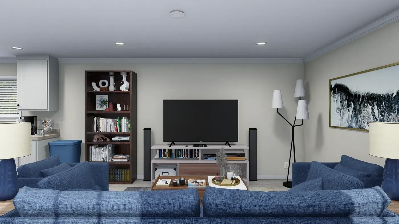 Living room with blue sofas, TV, bookcase, and wall art; neutral walls and floor.
