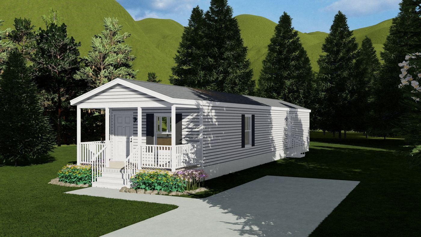 White manufactured home with a porch, driveway, and lush green surroundings.