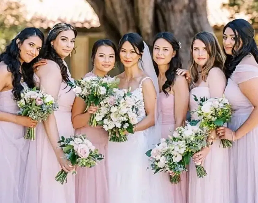 Bridesmaids wearing elegant hairstyles and natural wedding makeup