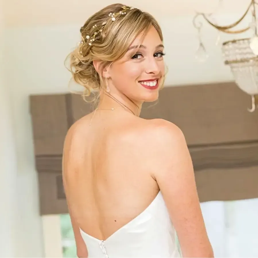Detailed bridal updo with glowing skin and neutral makeup