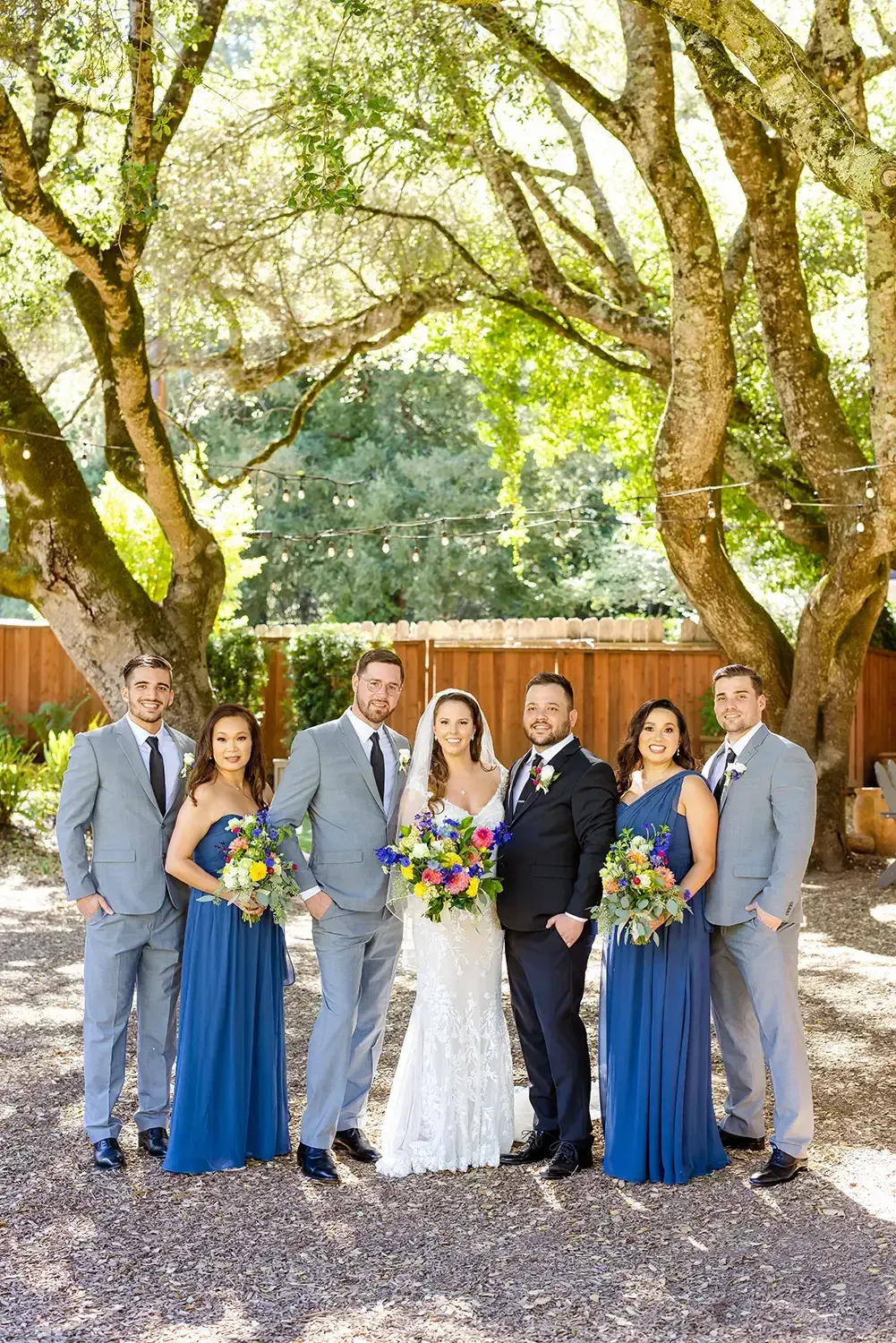Beautiful bridal party posing outdoors in soft afternoon light

