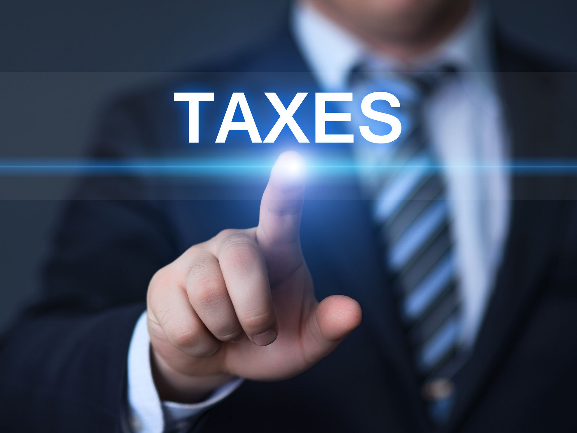 Businessperson pressing a glowing button labeled “TAXES”