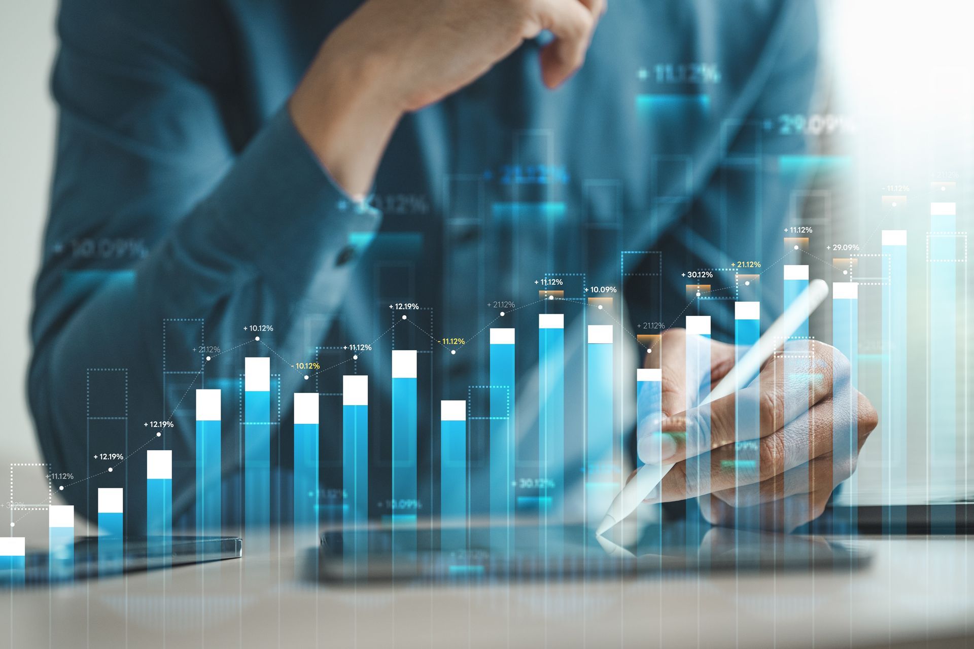 Person analyzing a rising bar chart on a digital tablet, with glowing financial data overlay