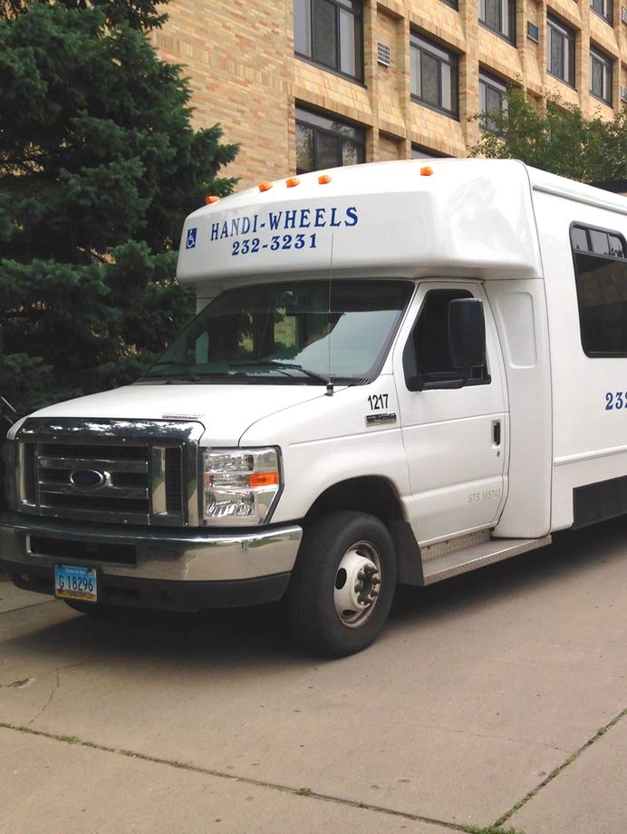 Handi-Wheels bus front outside a building