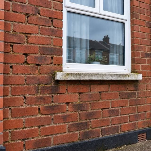 Valley-side stone wall before and after repointing before