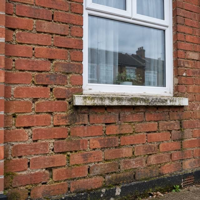 Brick house front repointing before