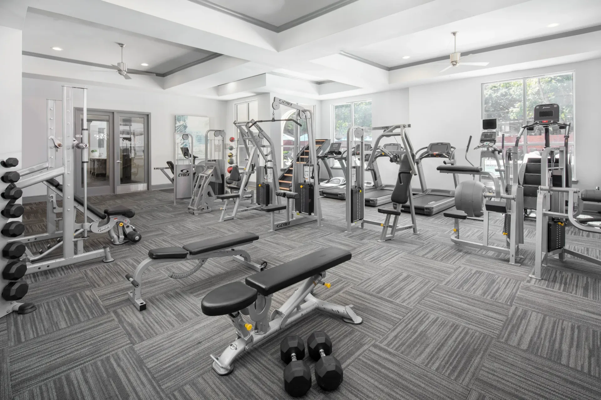 Well-equipped gym with exercise machines and weights at Marquis Enclave, offers apartments and lofts near HCC Central Campus.