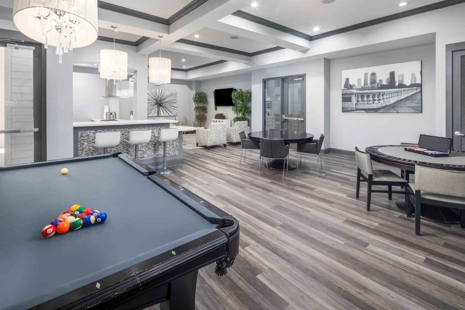 Game room with a pool table, bar, and seating area.