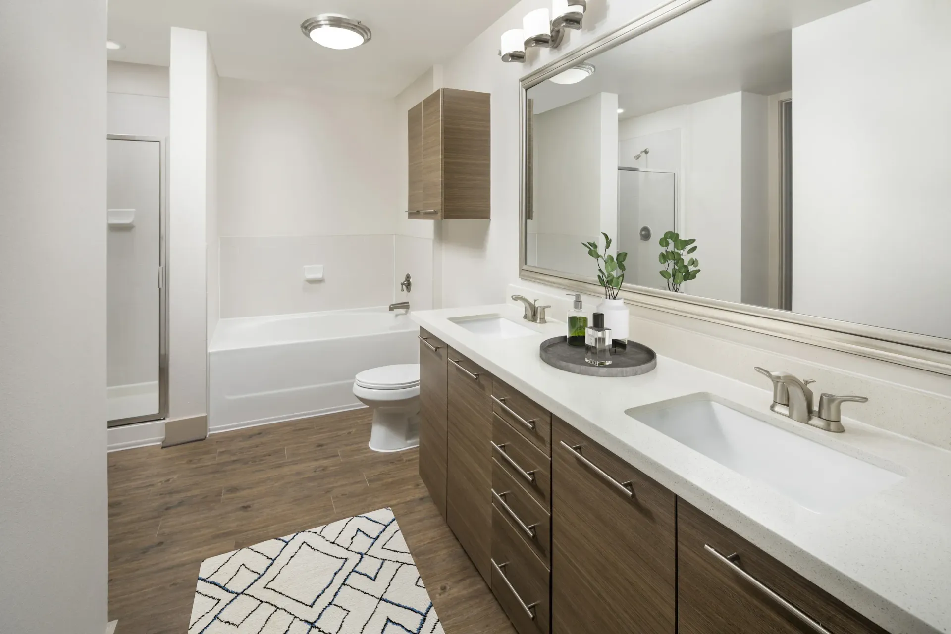 Modern bathroom with double sinks and stylish decor at Marquis Enclave, offers apartments and lofts in Midtown Houston, TX.