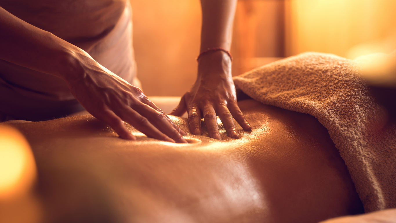 A woman is giving a man a massage in a spa.