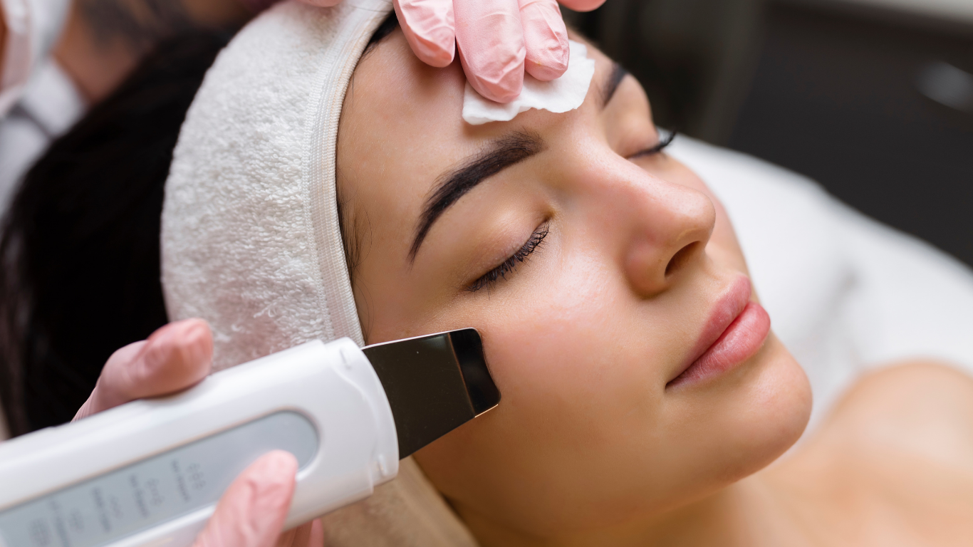 A woman is getting a facial treatment at a spa.
