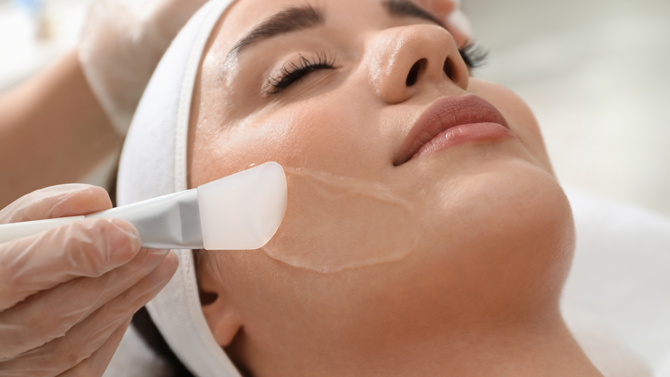 A woman is getting a facial treatment at a beauty salon.