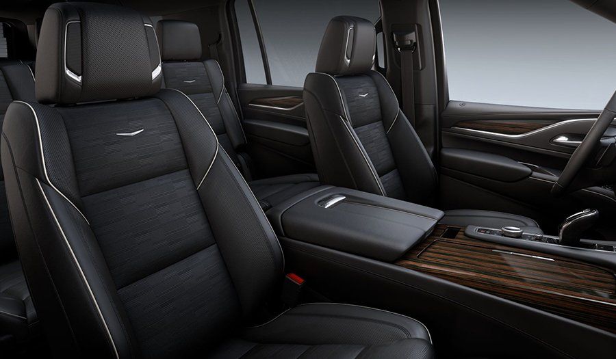 Luxurious car interior with black leather seats and wood-trimmed center console