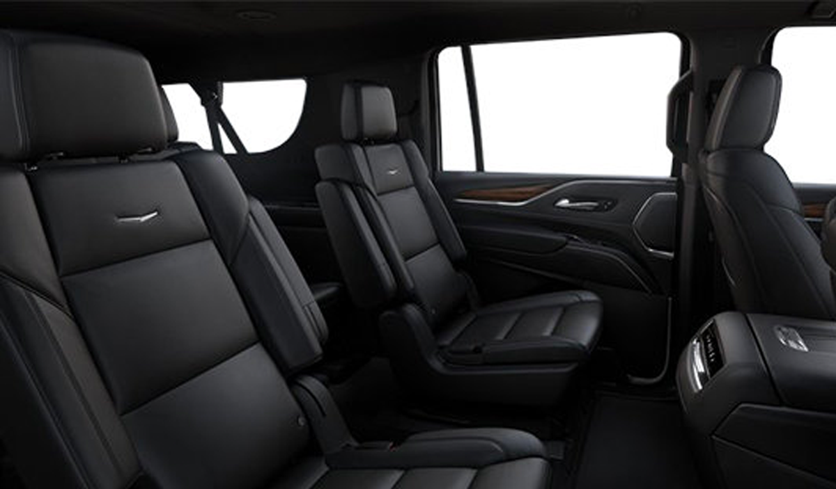 Black leather SUV interior with three-row seating and large windows