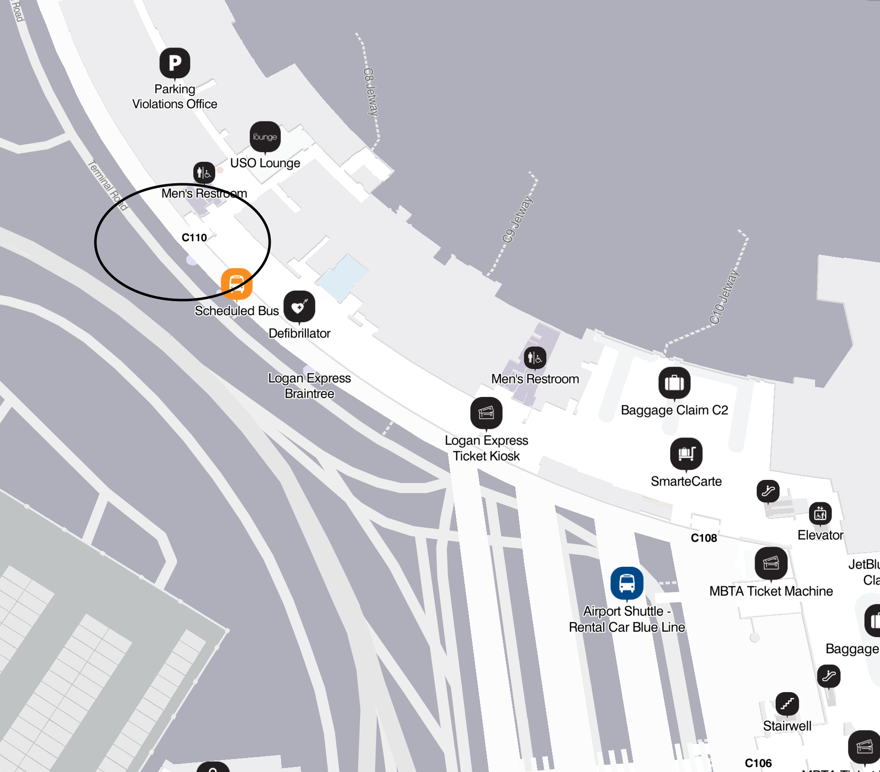 Annotated map of a parking lot with icons and a circled area near the entrance.