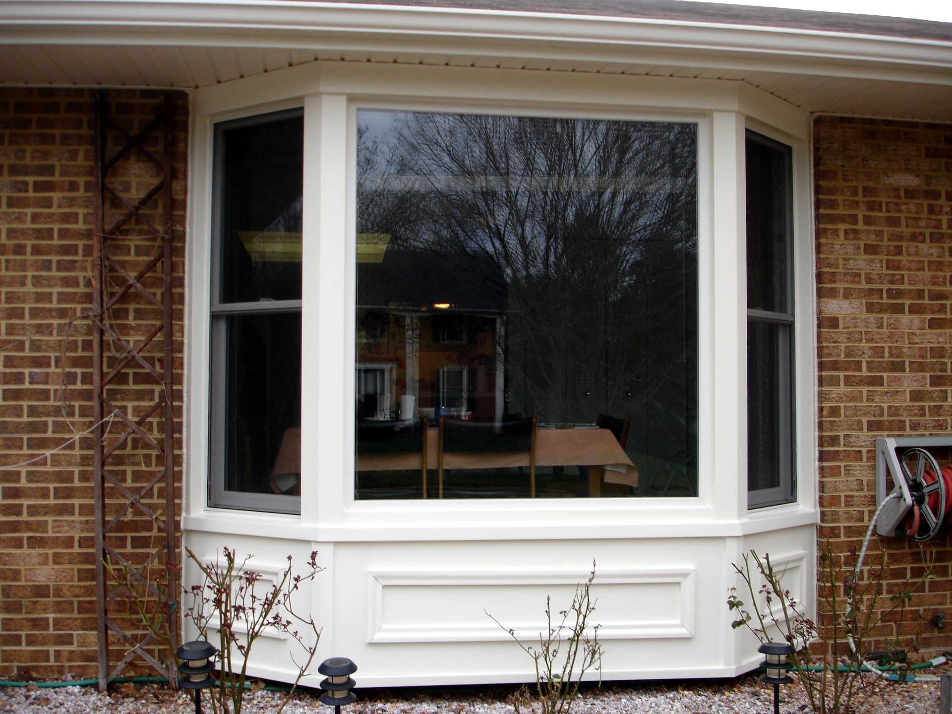 A brick house with a large bay window