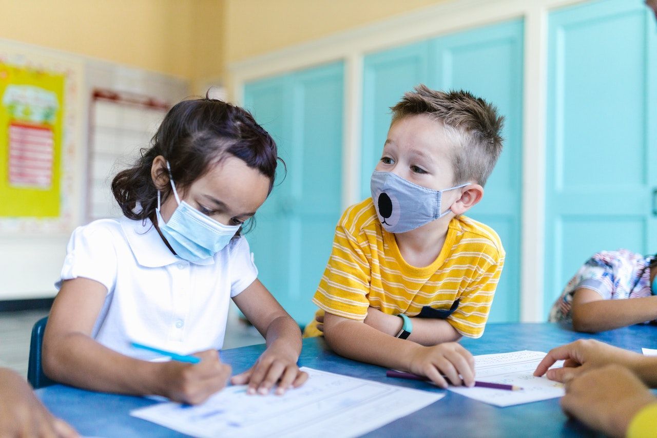 girl and boy in preschool or kindergarten doing their writing activity