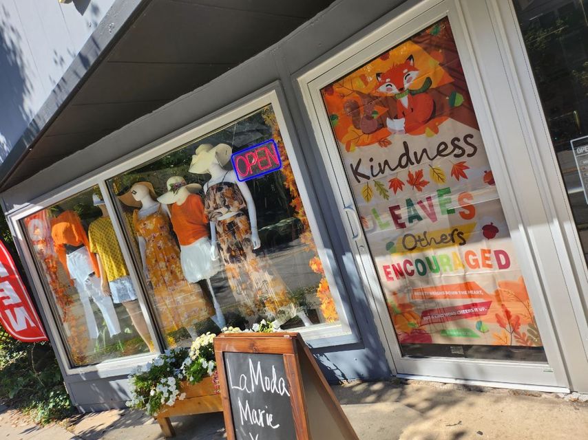 A store front with a sign that says kindness saves lives
