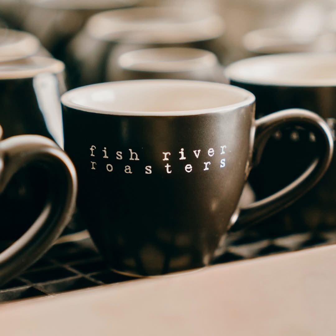 A Focused Shot Of A Mug With Branding On The Front WIth Other Mugs Around — Cafe Nosh in Taree, NSW