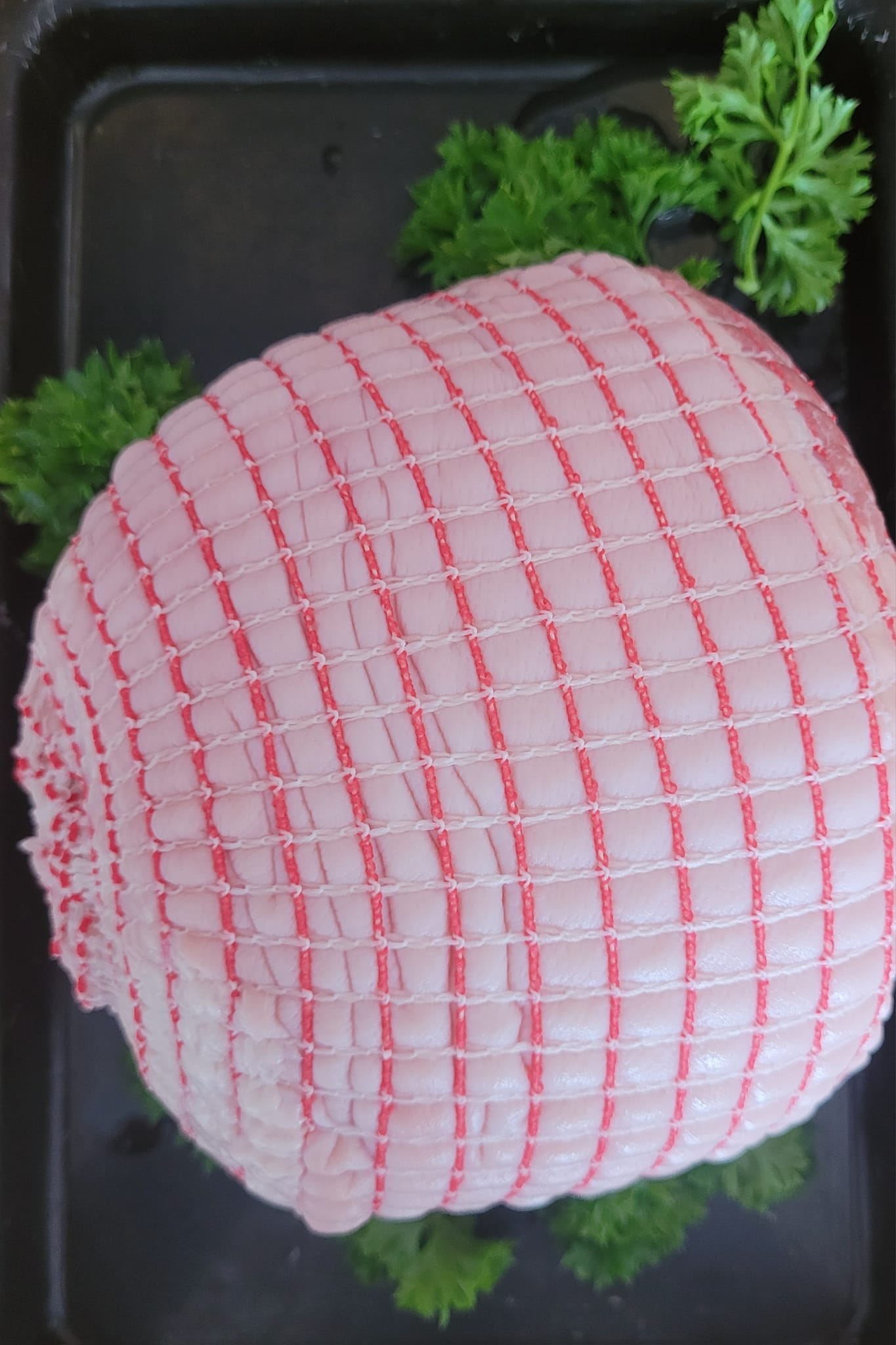 Raw, Tied Meat Roast in Red Netting — Drovers Meats in Coffs Harbour, NSW