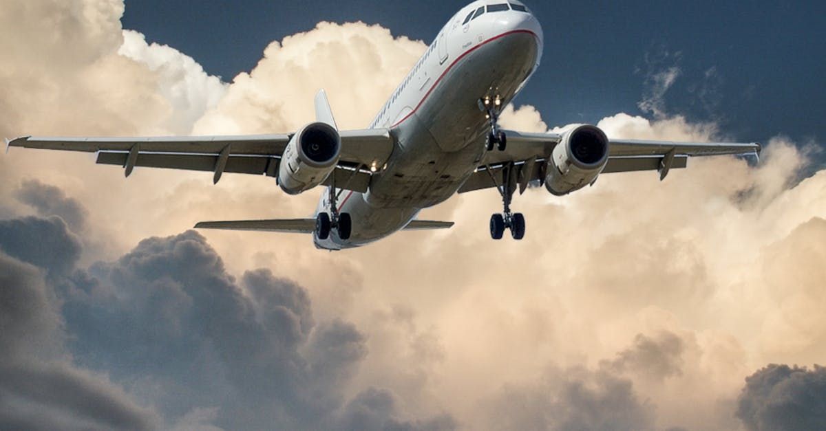 A large passenger jet is flying through a cloudy sky.