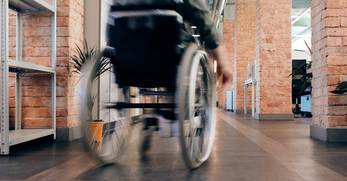 A person in a wheelchair is walking down a hallway.
