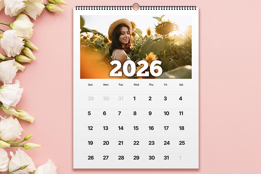 A calendar with flowers on a wooden table