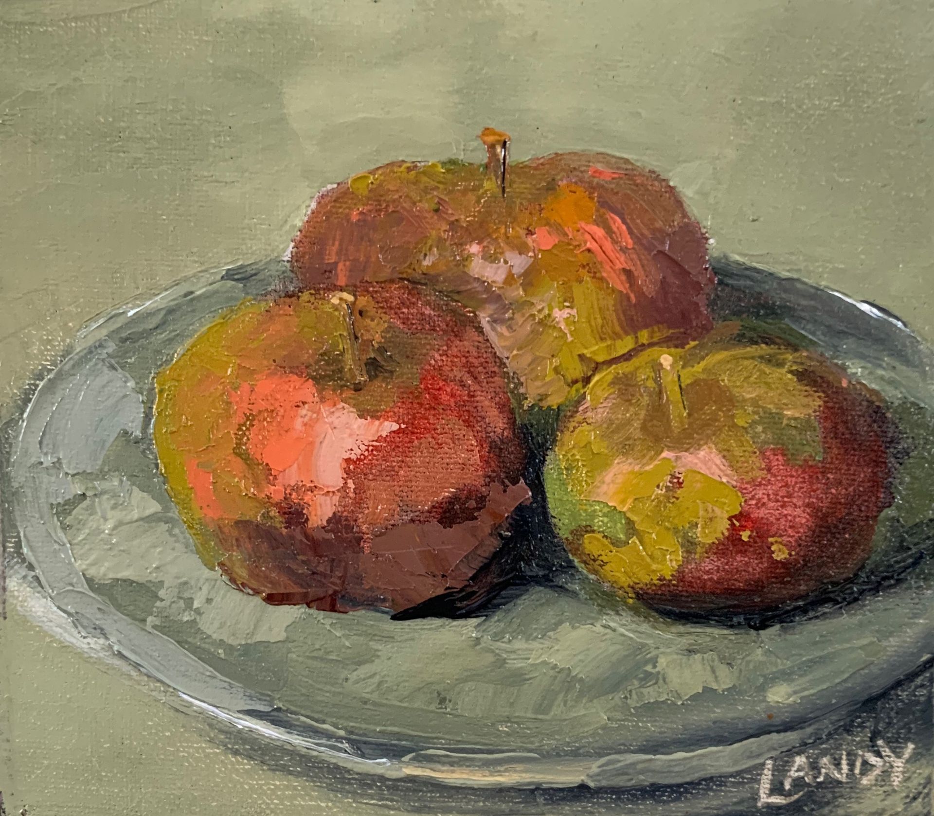 Three apples on a gray plate, painted in warm red, green, and yellow tones.