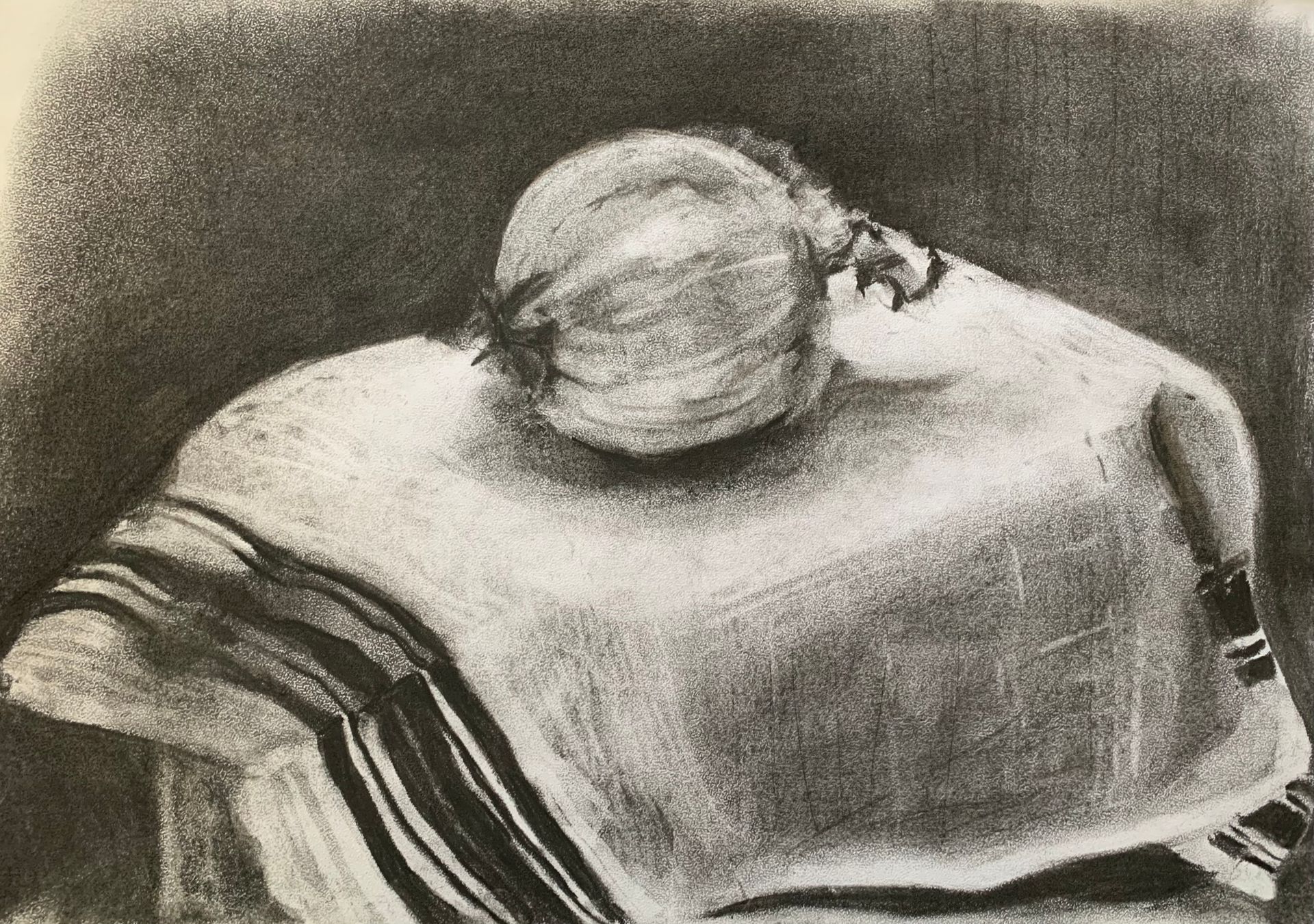 A striped cloth with a round onion resting on top in a monochrome drawing