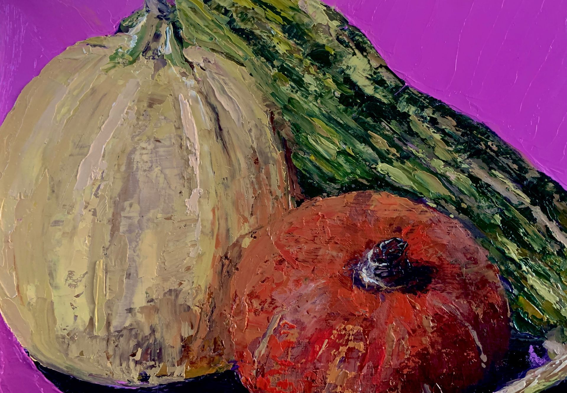 Two gourds, one pale and one red, resting on a green leaf against a purple background