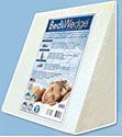 A white wedge pillow with a picture of a person sleeping on it.