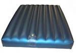 A black inflatable mattress with a hole in the middle on a white background.
