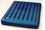 A blue inflatable mattress is sitting on top of a white surface.