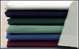 A pile of sheets of different colors are stacked on top of each other.