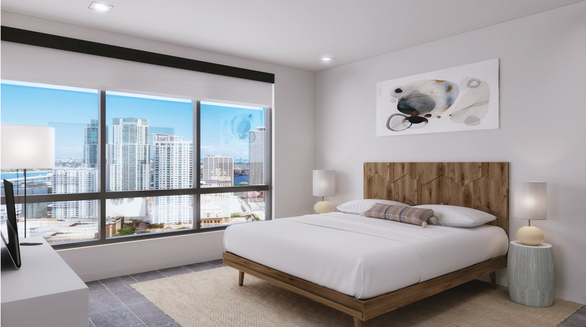 Modern apartment bedroom with a wooden headboard, white bedding, and a city skyline view.