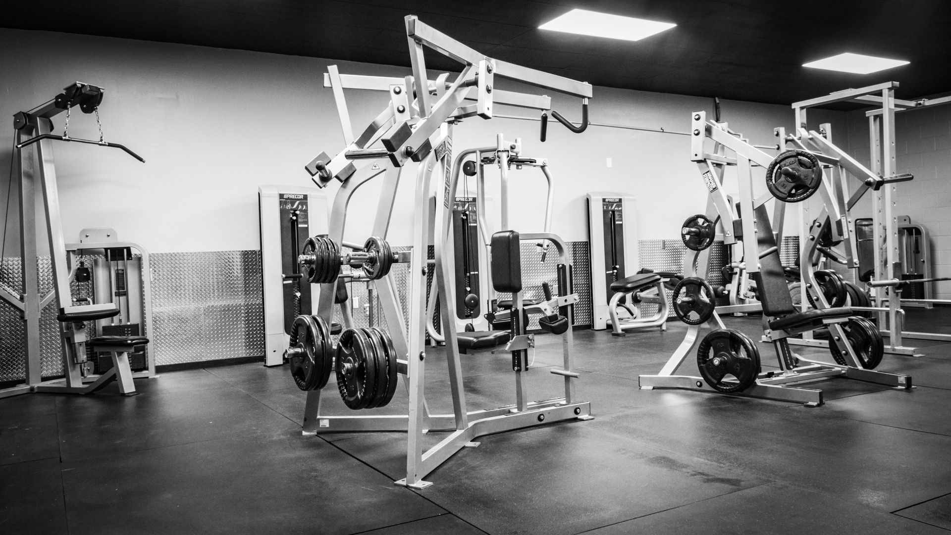 Cable machines and barbell racks at Fitness @ KT Black private training gym in Amarillo, TX