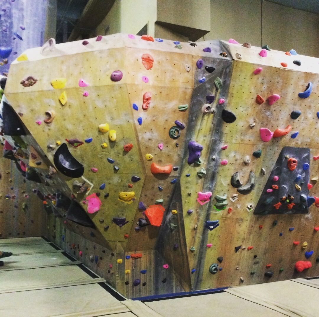 A large climbing wall with lots of rocks on it