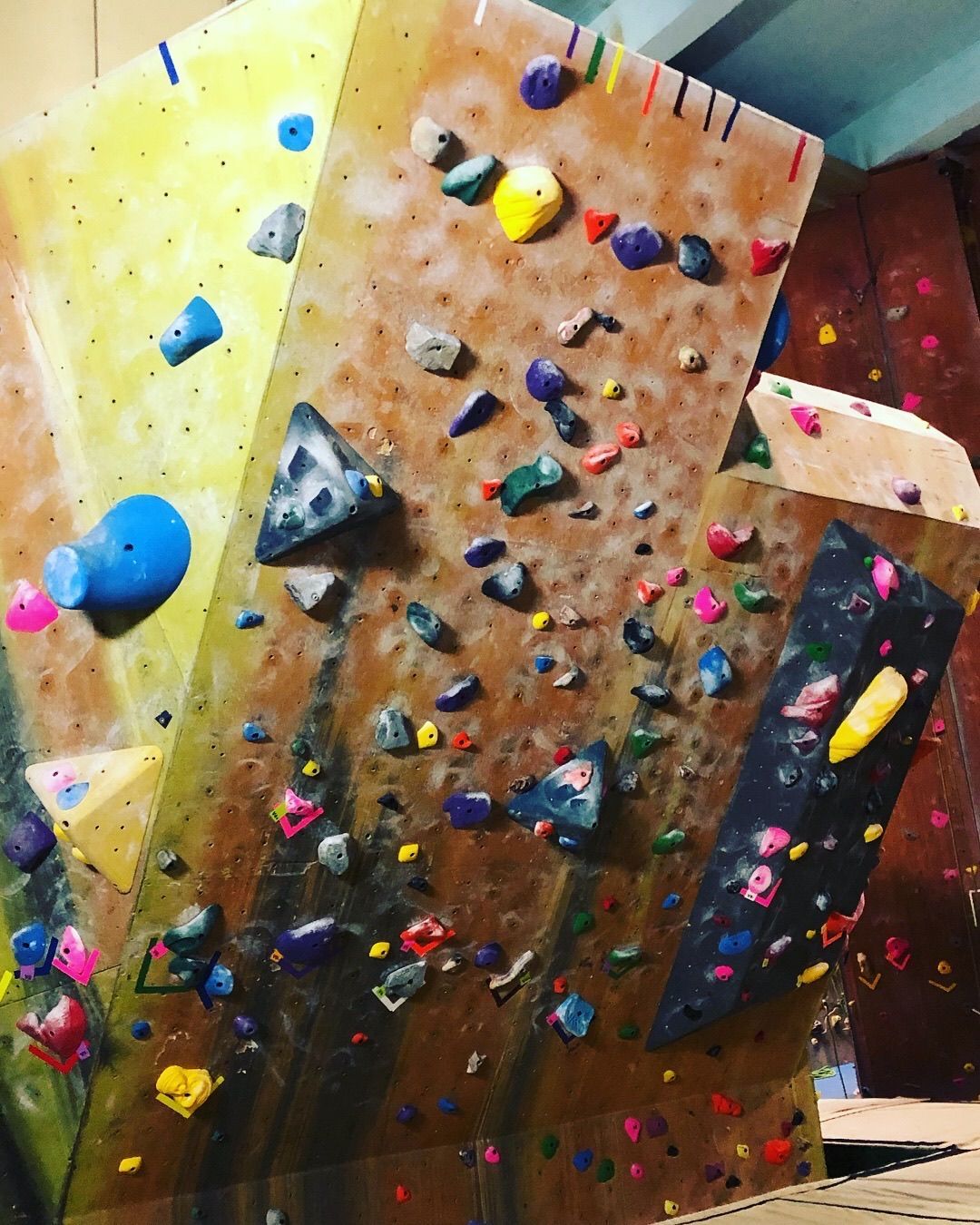 A climbing wall with a lot of rocks on it