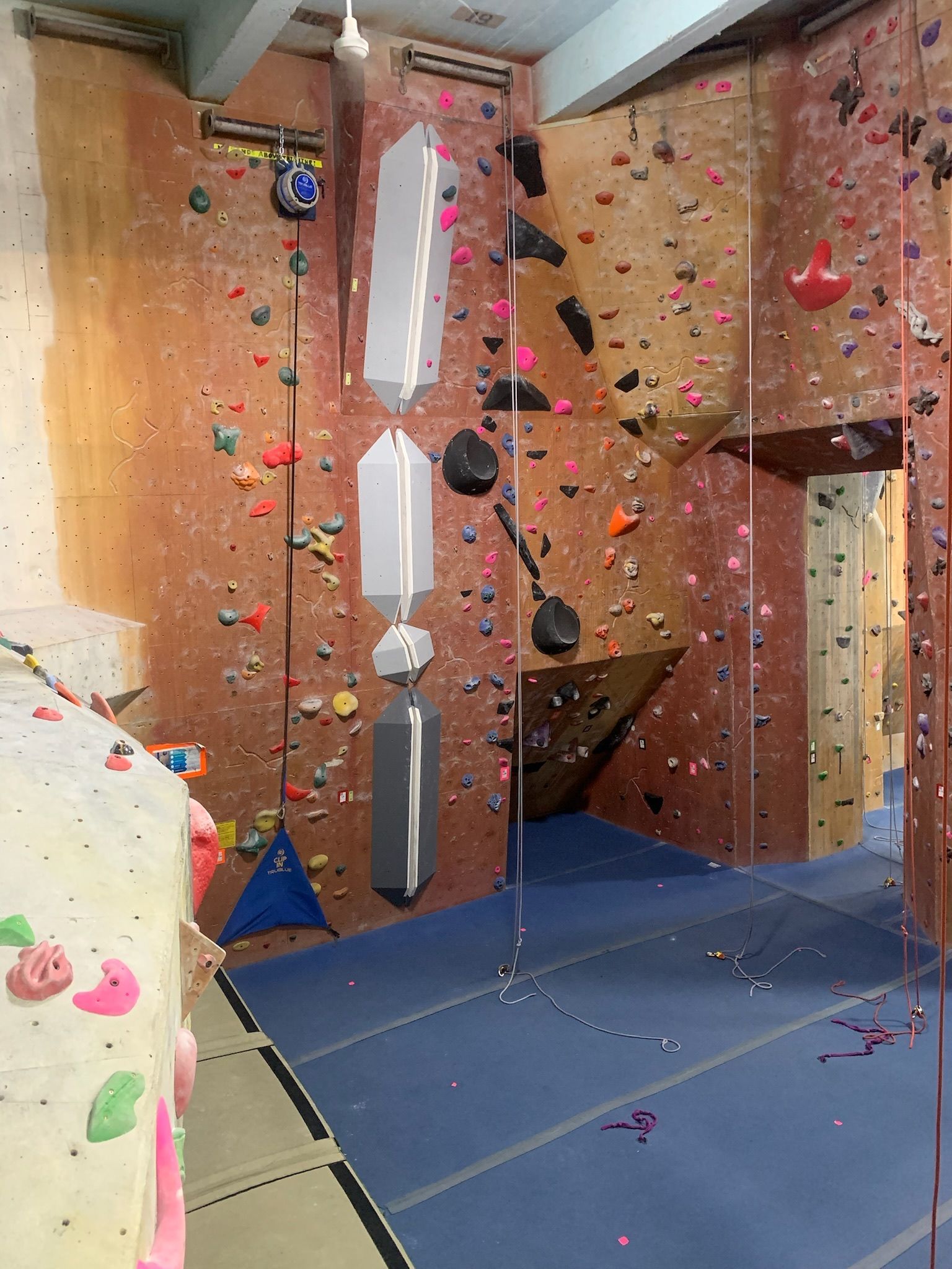 There is a climbing wall in the middle of the room.