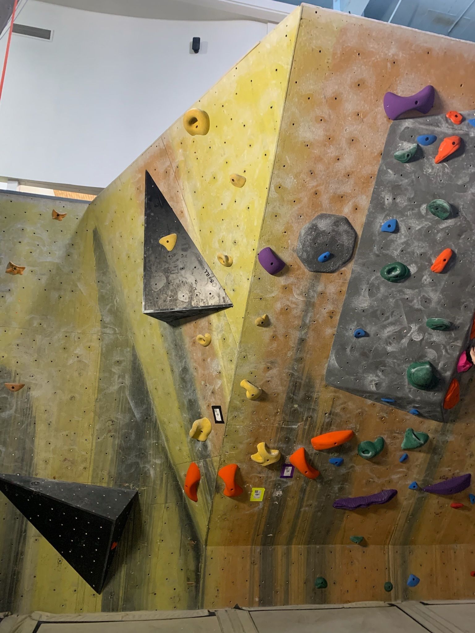 A climbing wall with a lot of climbing holds on it