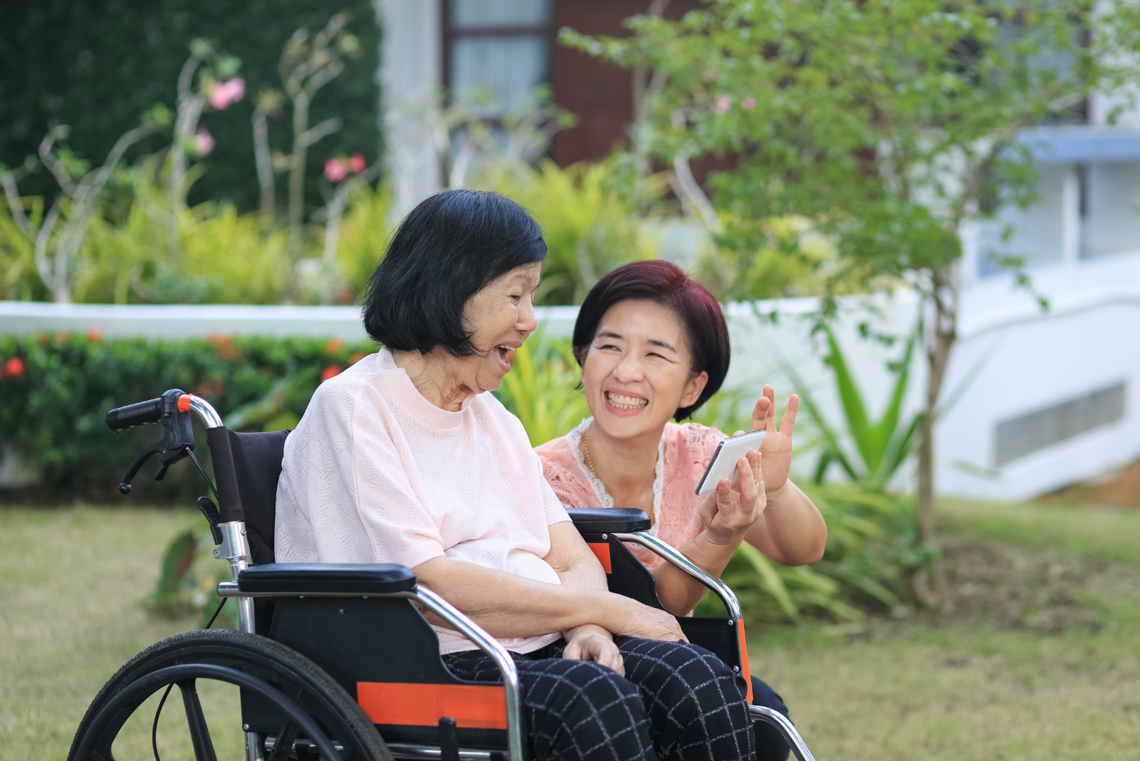 a woman in a wheelchair is talking to another woman .