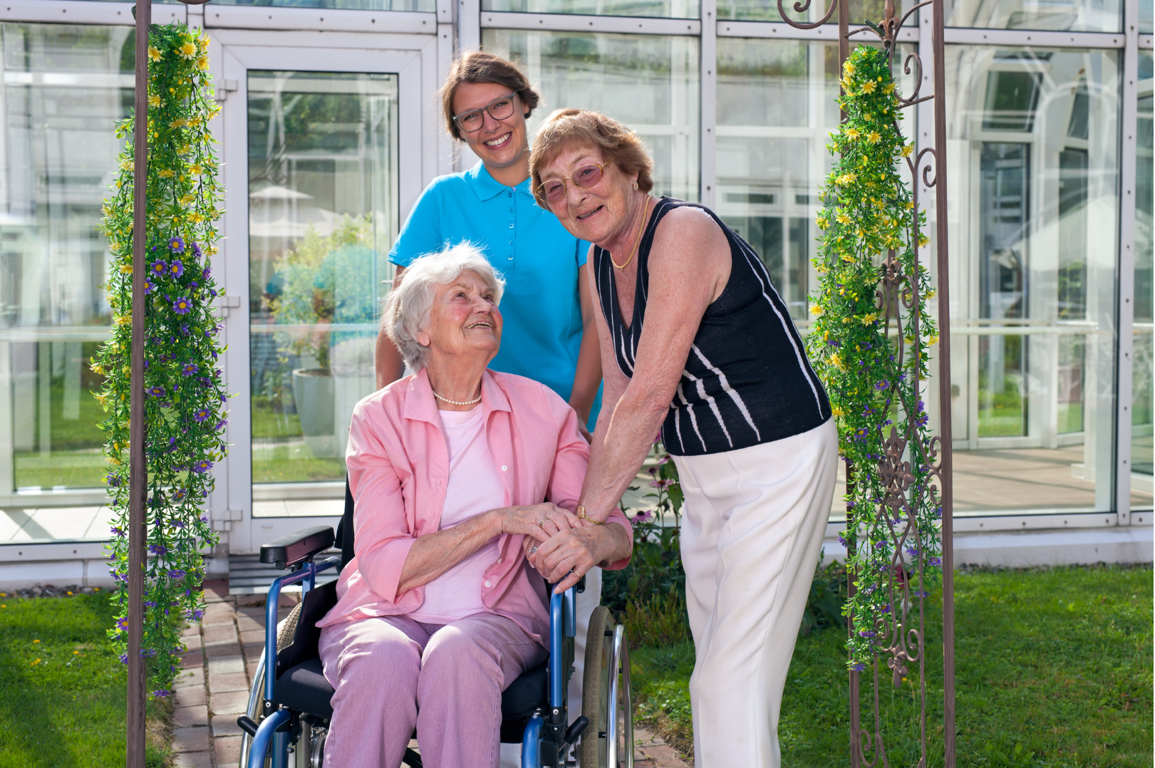 a woman in a wheelchair is being helped by two other women