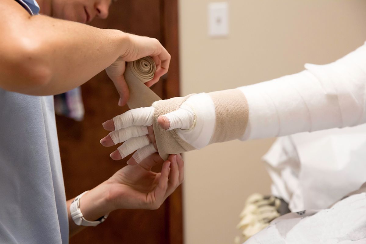a person is getting a bandage on their arm .