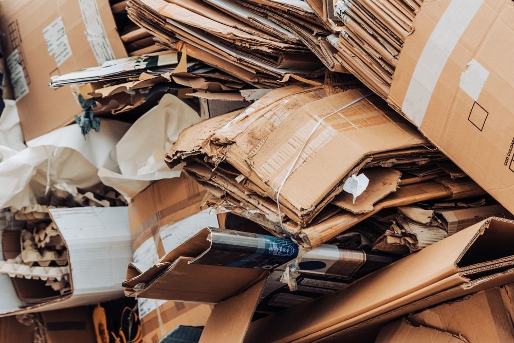 Pile of flattened and torn cardboard boxes.