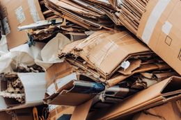 Piles of flattened cardboard boxes and packing debris in a storage area