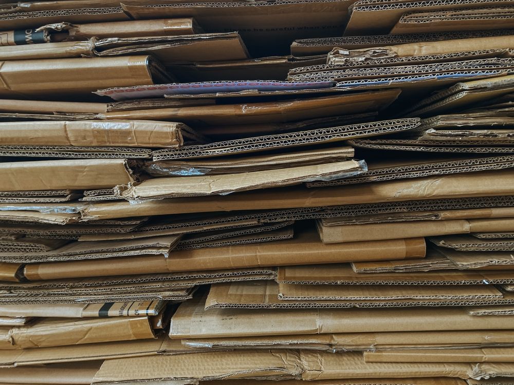 Pile of flattened corrugated cardboard pieces.