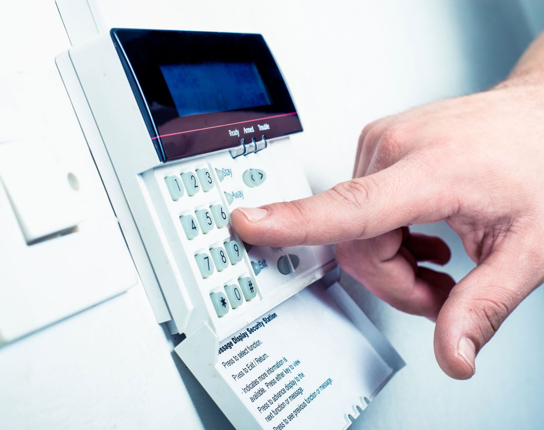 Typing security code on alarm keys | Sydney, NSW | TEC Security