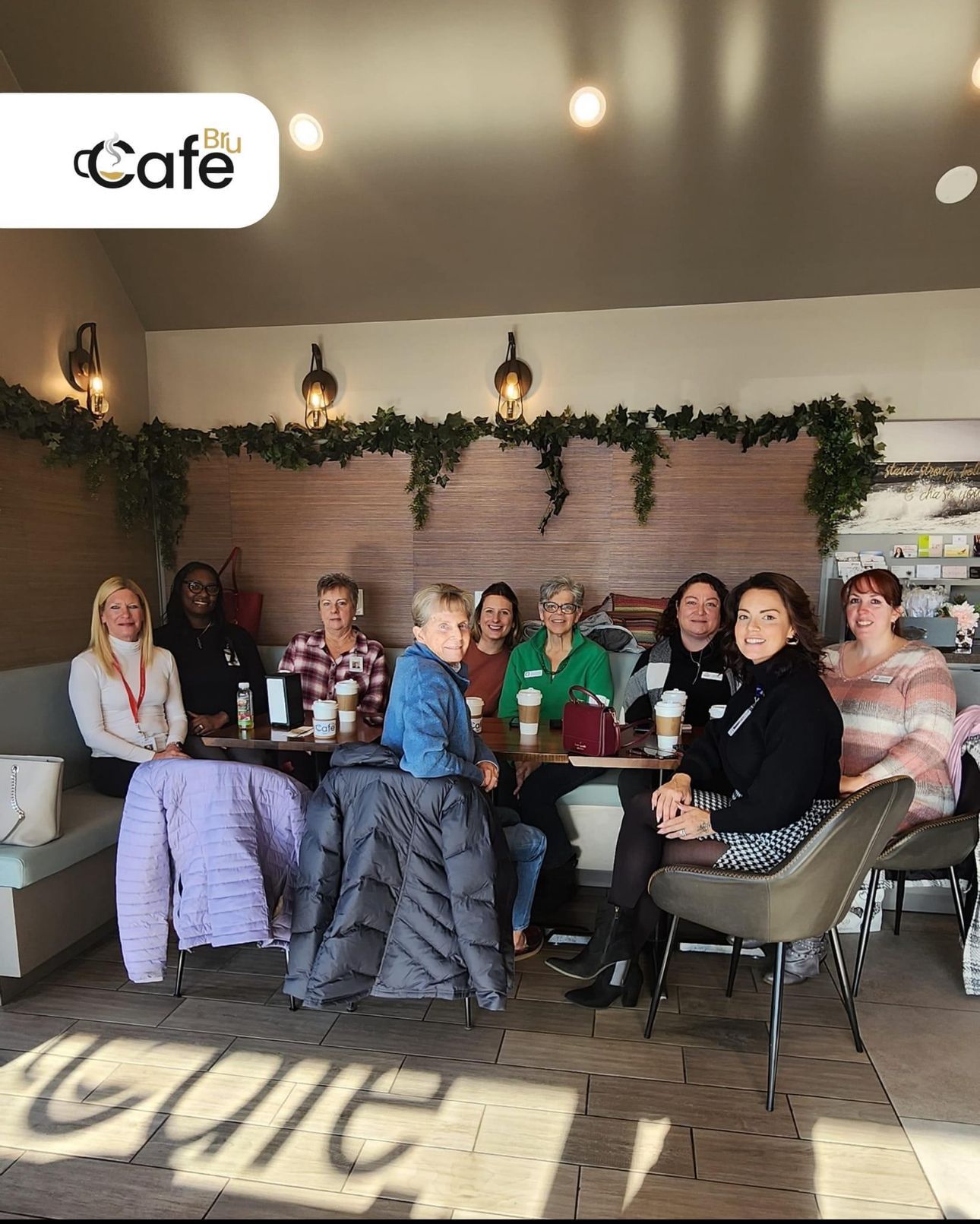 a group of people are sitting at tables in a cafe