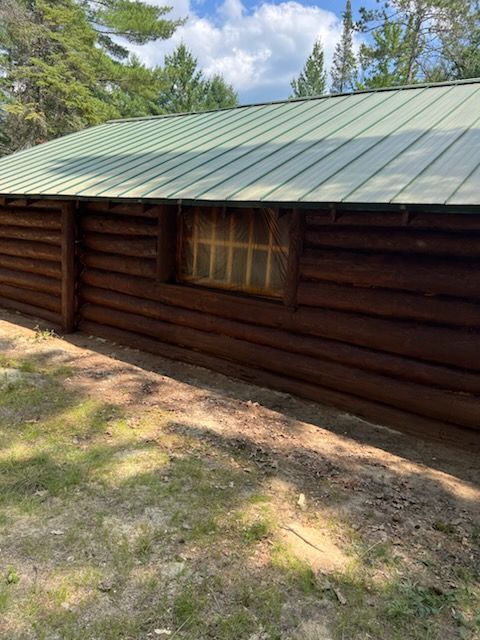 A large log cabin with a black roof