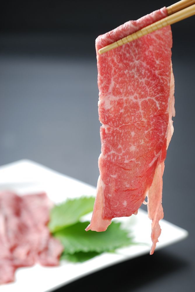 Chopsticks Holding A Piece Of Meat Over A Plate Of Meat — Start Fresh Fruit Market in Bundaberg Central QLD